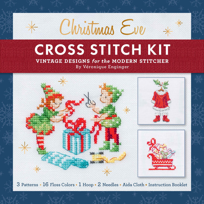 The Christmas Eve Cross Stitch Kit: Cozy Vintage Patterns for the Holidays packaging features finished Christmas vignettes of two elves wrapping a gift, a Santa outfit, and a sleigh, with a list of included supplies at the bottom.