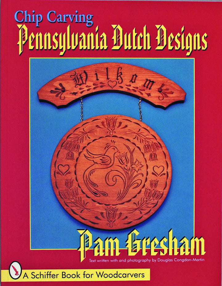 Cover of Schiffer Publishing's "Chip Carving Pennsylvania Dutch Designs" shows carved wooden plaques with chip carving motifs and the word “Wilkom” on a red and blue background.